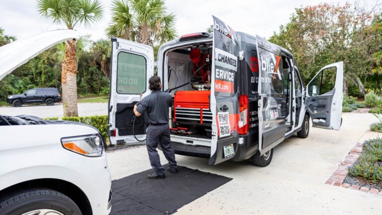 Employee pulling the hose out of the van